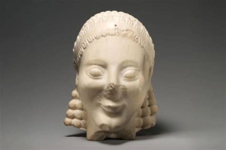 Why was an archaic smile added to these sculptures?